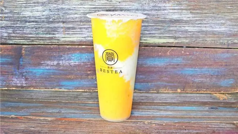 Mango Bubble Tea - Vibrant yellow tea with mango flavor and creamy swirls at Bestea & Sushi, a Japanese restaurant in Oviedo